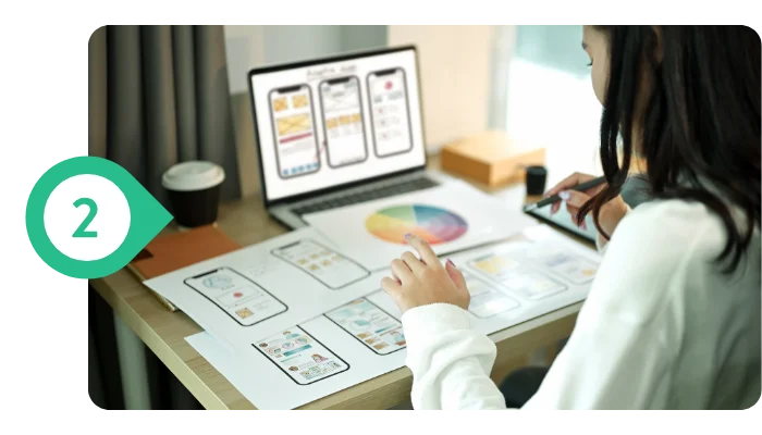 Designer creating UI/UX layout and visual interface for a modern custom website on a professional development workspace.